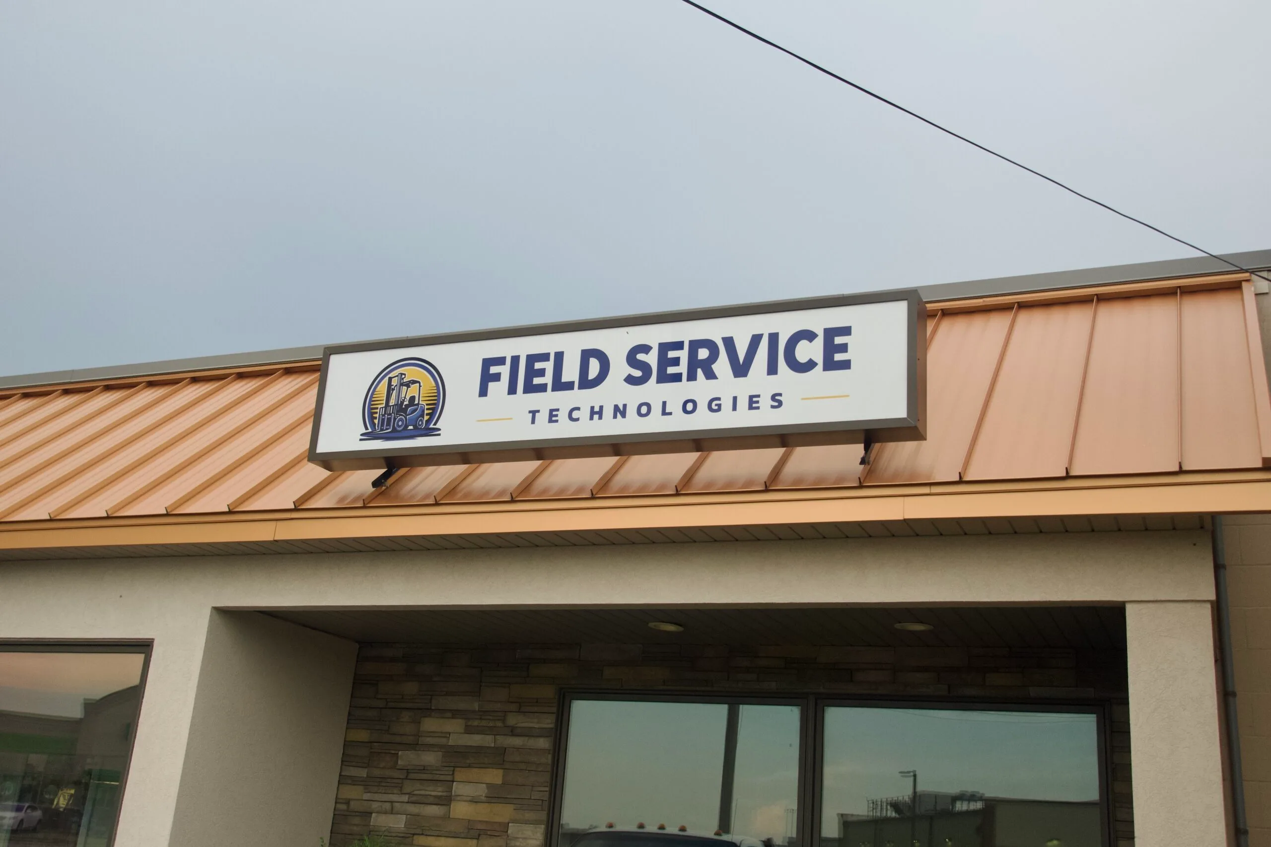 Illuminated storefront cabinet sign fabricated and installed by Best Made Signs